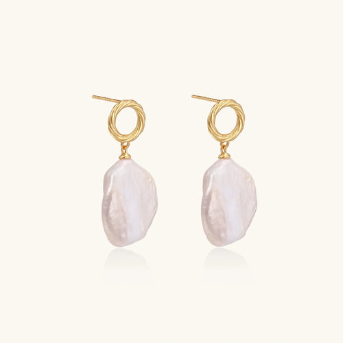 18K gold vermeil twisted circle studs with organic white baroque pearl drops on cream background