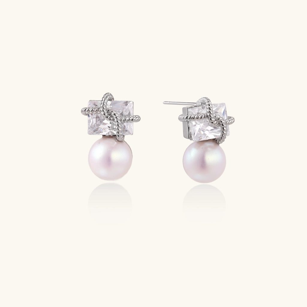 White gold stud earrings with square crystal stones in twisted frames and pink freshwater pearl drops below