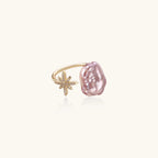 Adjustable gold ring with pink baroque freshwater pearl and crystal-studded star charm on white background