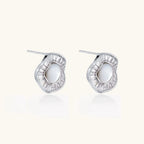 Round white gold-plated stud earrings with mother of pearl center and baguette crystal halo surround, 16.2mm diameter.